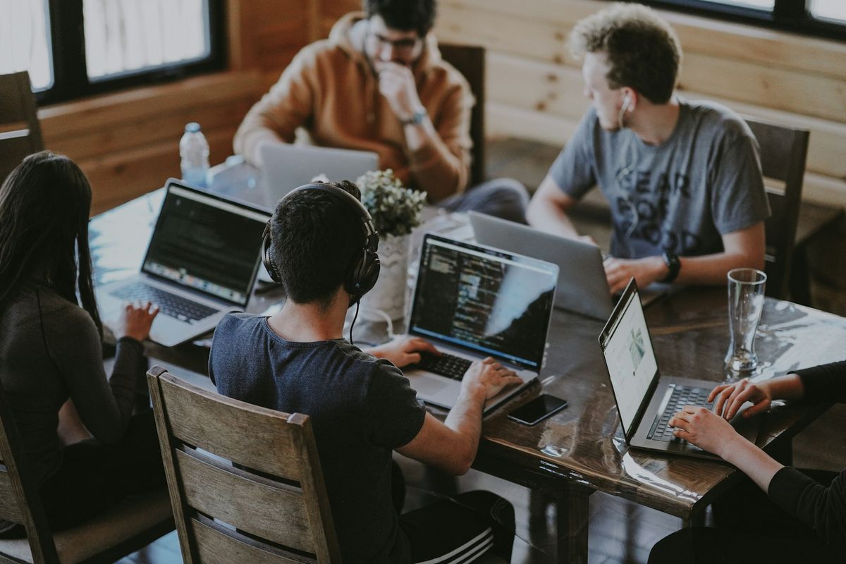 Team i gründermiljø jobber sammen med laptop